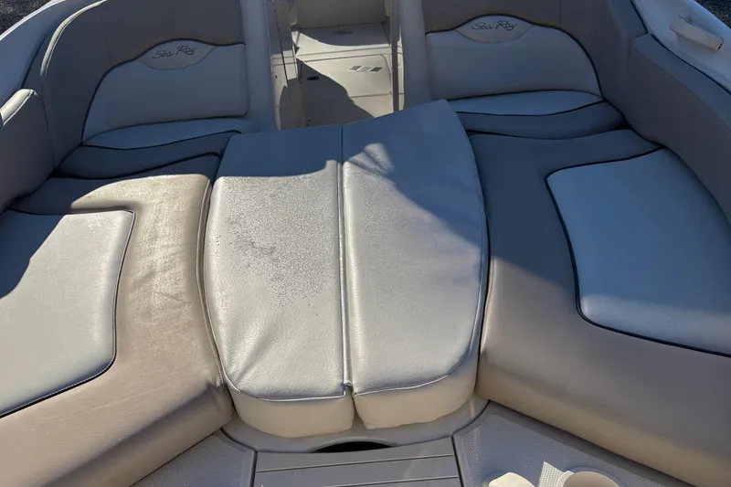 Slide: The Image of 2004 Sea Ray 240 Sundeck interior seating with light gray upholstery. - 16