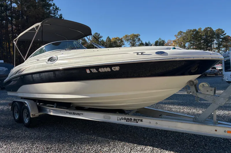 Slide: The Image of 2004 Sea Ray 240 Sundeck boat on trailer, parked outdoors. - 7