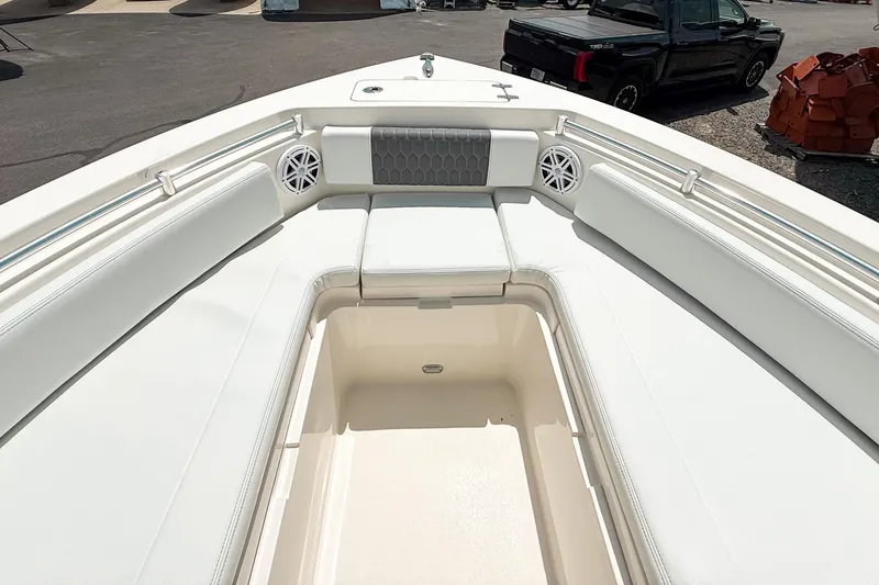 Slide: The Image of 2025 Cobia 220 Dual Console boat interior with spacious seating and storage. - 17