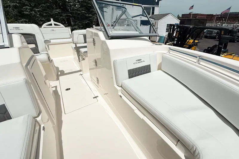 Slide: The Image of 2025 Cobia 220 Dual Console boat interior with white seating and sleek design. - 19