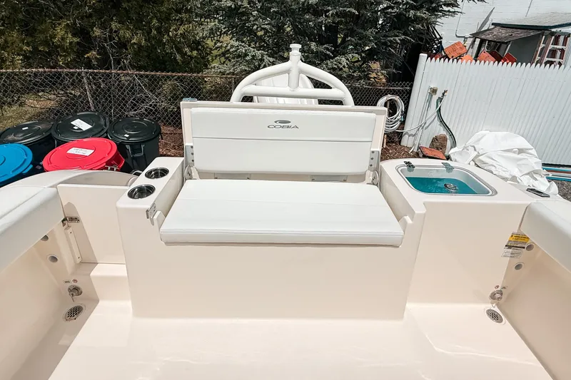 Slide: The Image of 2025 Cobia 220 Dual Console boat interior with seating and cup holders. - 4