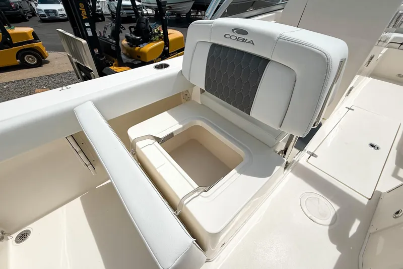 Slide: The Image of 2025 Cobia 220 Dual Console boat seat with storage compartment, showcasing sleek design and functionality. - 7