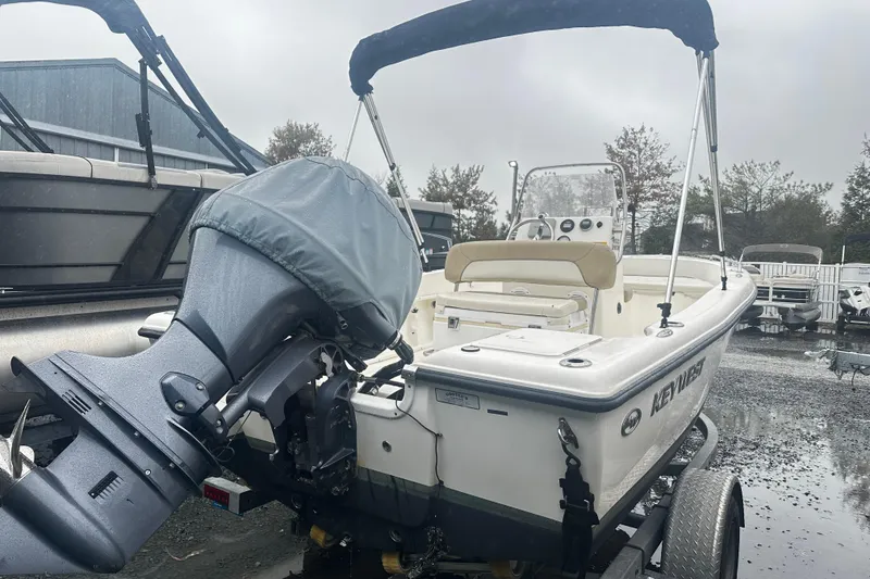 Slide: The Image of 2018 Key West 186 Center Console boat on trailer, featuring covered outboard motor. - 2