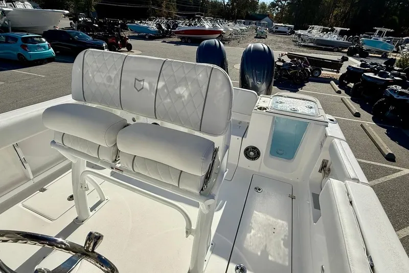 Slide: The Image of 2026 Sea Fox 268 Commander boat interior with white seating and dual engines. - 11