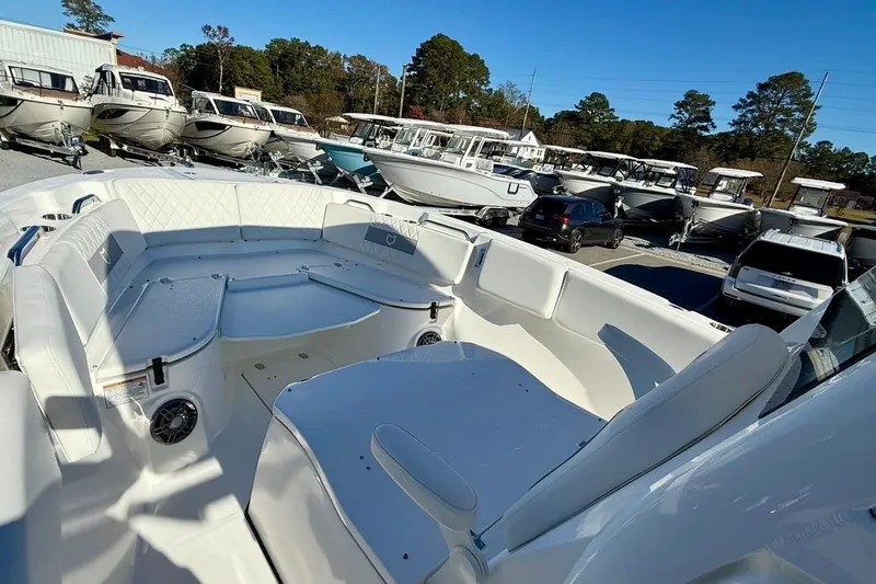 Slide: The Image of 2026 Sea Fox 268 Commander boat interior with seating, parked among other boats. - 12