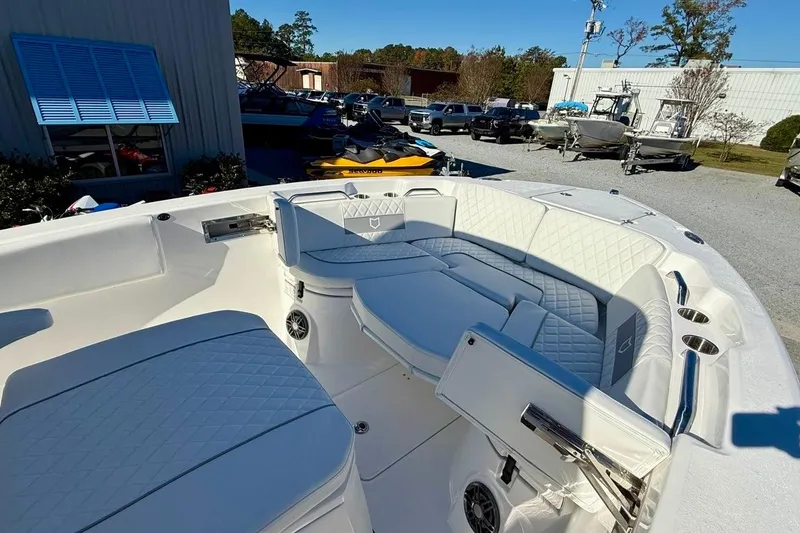 Slide: The Image of 2026 Sea Fox 268 Commander boat interior with white cushioned seating and storage compartments. - 21