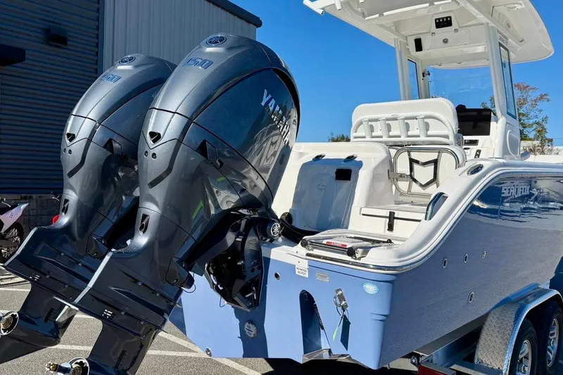 Slide: The Image of 2026 Sea Fox 268 Commander boat with dual Yamaha outboard engines, parked outdoors. - 3
