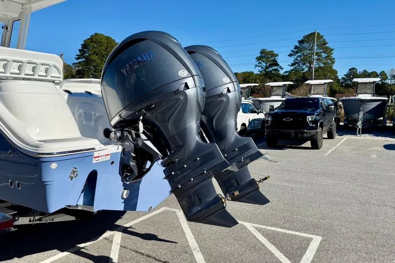 Slide: The Image of 2026 Sea Fox 268 Commander with dual Yamaha outboard motors in a parking lot. - 4