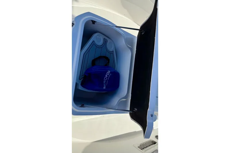 Slide: The Image of Open storage compartment on 2026 Sea Fox 268 Commander boat with blue bag inside. - 7