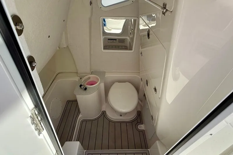 Slide: The Image of 2026 Sea Fox 268 Commander boat bathroom with toilet, sink, and mirror. - 9