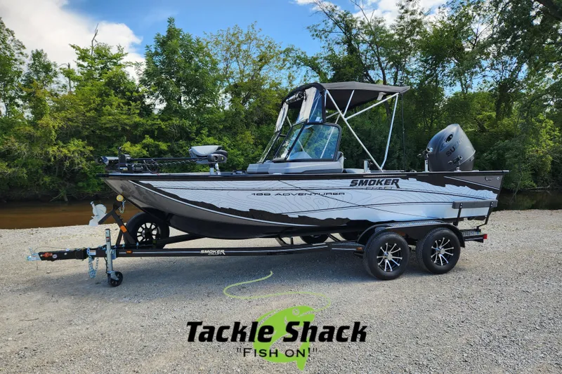 Slide: The Image of 2026 Smoker Craft Adventurer 188 DC PRO boat on trailer, surrounded by trees and gravel. - 22
