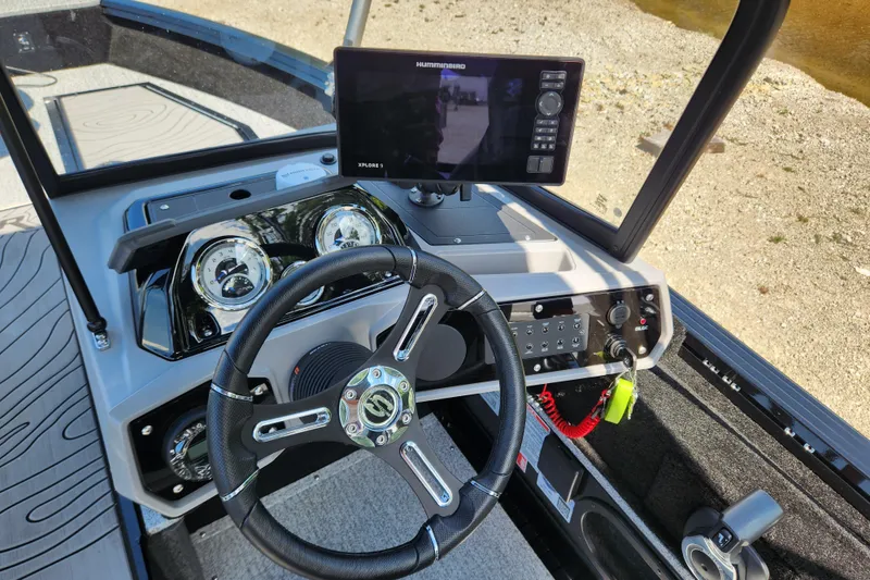 Slide: The Image of 2026 Smoker Craft Adventurer 188 DC PRO dashboard with steering wheel and navigation display. - 29