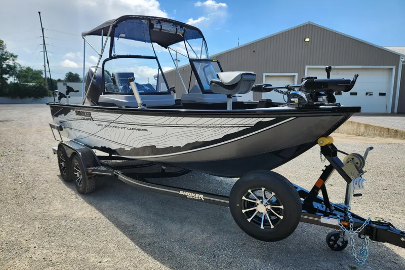 Slide: The Image of 2026 Smoker Craft Adventurer 188 DC PRO boat on trailer, parked outdoors. - 4