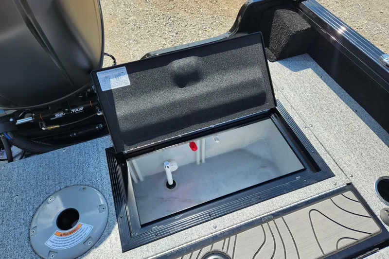 Slide: The Image of 2026 Smoker Craft Adventurer 188 DC PRO boat storage compartment with open lid. - 7