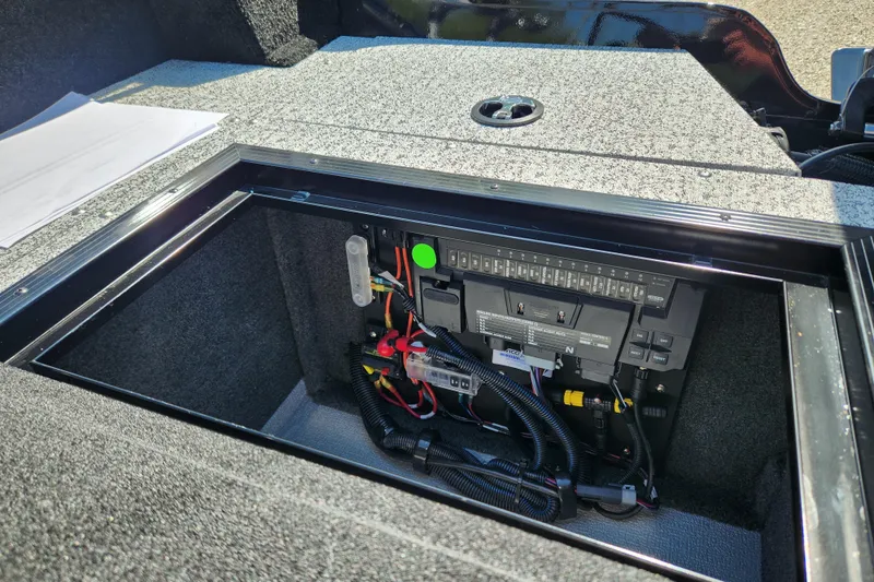 Slide: The Image of 2026 Smoker Craft Adventurer 188 DC PRO boat electrical panel with wiring and storage compartment. - 8