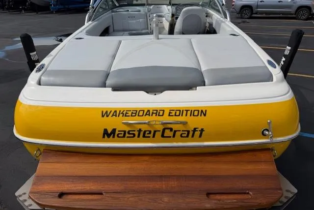 Slide: The Image of 2002 MasterCraft X30 Wakeboard Edition boat with yellow and white design, rear view. - 11