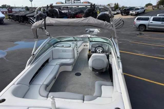 Slide: The Image of 2002 MasterCraft X30 boat interior with seating and dashboard, parked in a lot. - 12