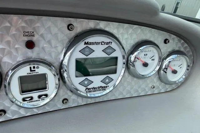 Slide: The Image of Dashboard of a 2002 MasterCraft X30 boat with gauges and controls. - 15