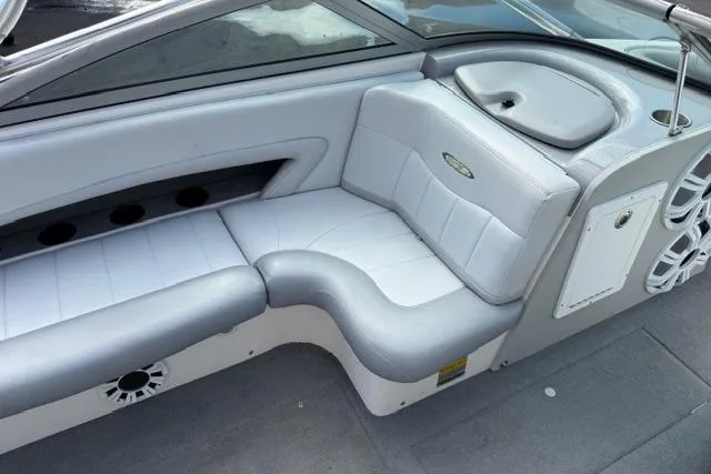 Slide: The Image of 2002 MasterCraft X30 boat interior with gray and white seating and cup holders. - 16