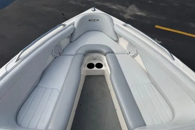 Slide: The Image of 2002 MasterCraft X30 boat interior with white cushioned seating and cup holders. - 18