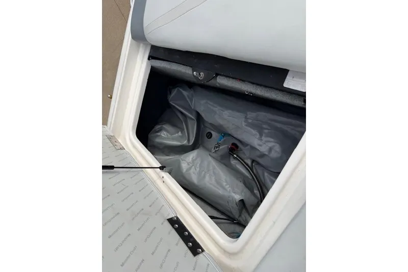 Slide: The Image of Open storage compartment in a 2002 MasterCraft X30 boat, showing interior details. - 20