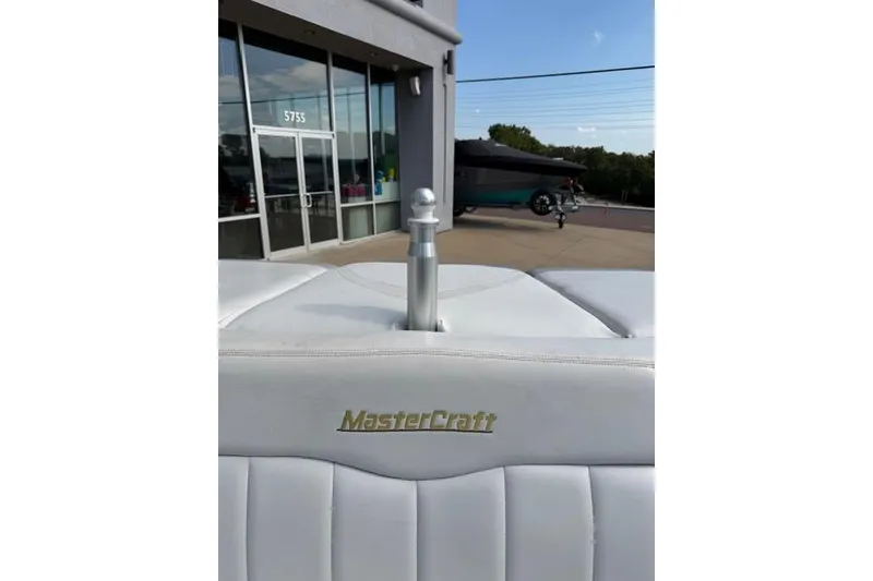 Slide: The Image of 2002 MasterCraft X30 boat interior with logo, parked outside a building. - 22
