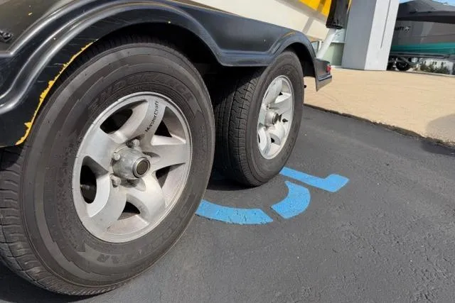 Slide: The Image of Trailer wheels of a 2002 MasterCraft X30 parked on asphalt. - 9