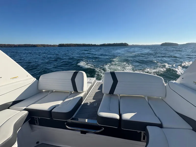 Slide: The Image of 2016 Regal 2300 Bowrider cruising on a sunny lake with comfortable seating. - 10