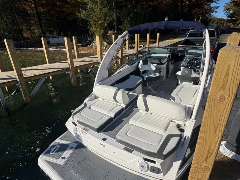 Slide: The Image of 2016 Regal 2300 Bowrider boat docked, featuring spacious seating and sleek design. - 11