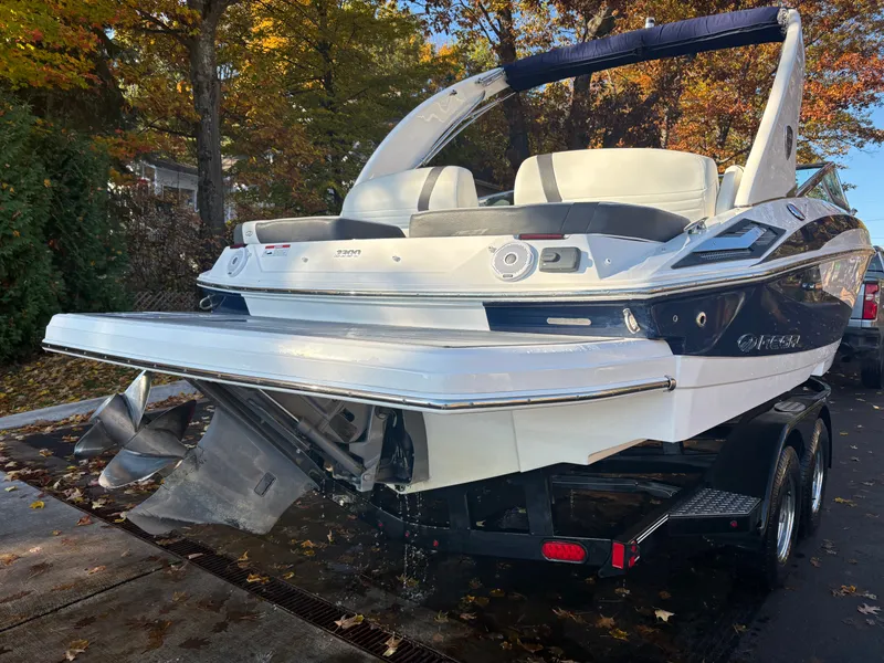 Slide: The Image of 2016 Regal 2300 Bowrider boat on trailer, surrounded by autumn foliage. - 13