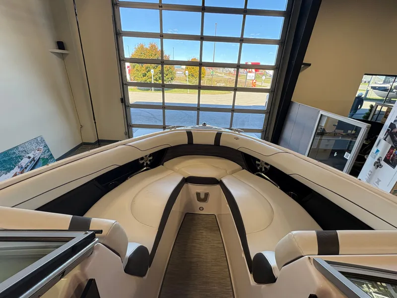 Slide: The Image of 2016 Regal 2300 Bowrider interior, showcasing spacious seating and modern design in showroom setting. - 2