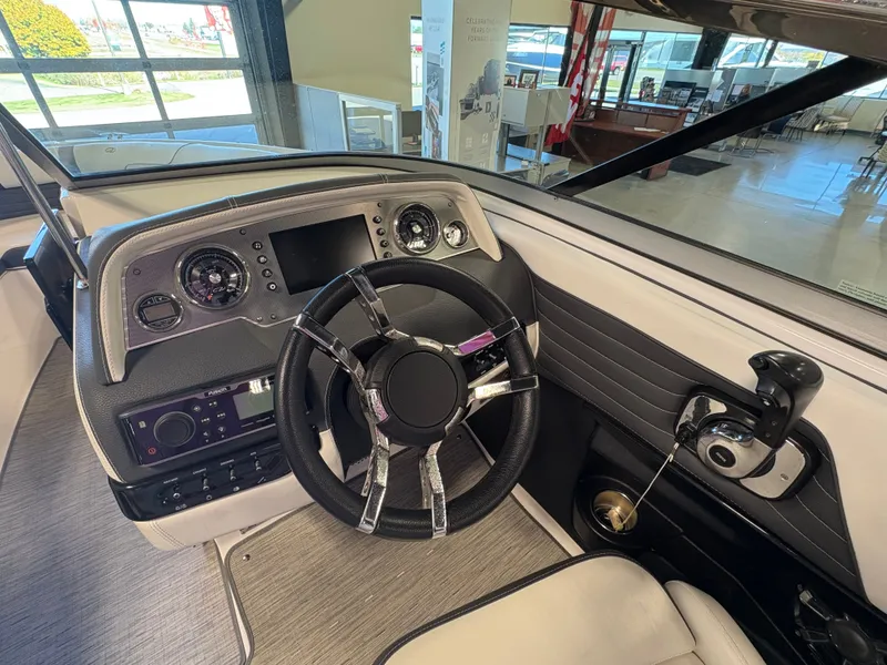 Slide: The Image of 2016 Regal 2300 Bowrider dashboard with steering wheel and control panel in showroom. - 5