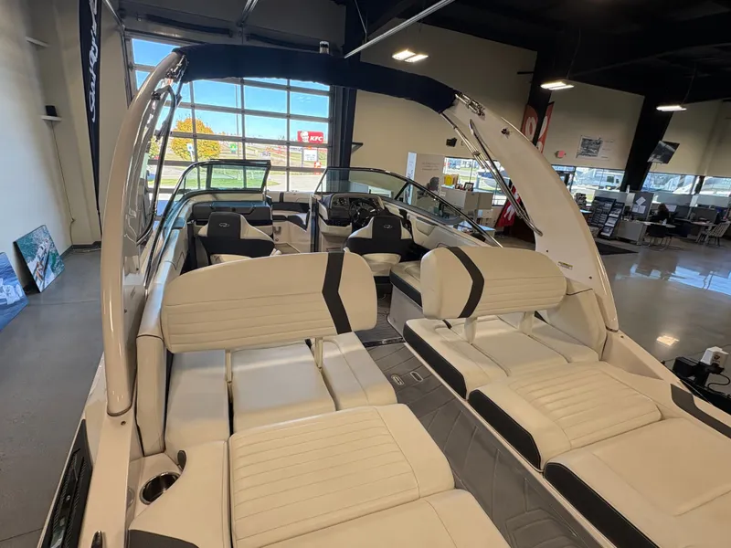 Slide: The Image of 2016 Regal 2300 Bowrider boat interior with white seating in showroom. - 8