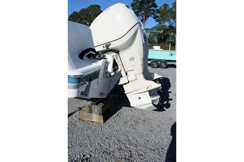 Slide: The Image of Outboard motor of 2008 Pro-Line 29 Express O/B boat on gravel surface. - 12