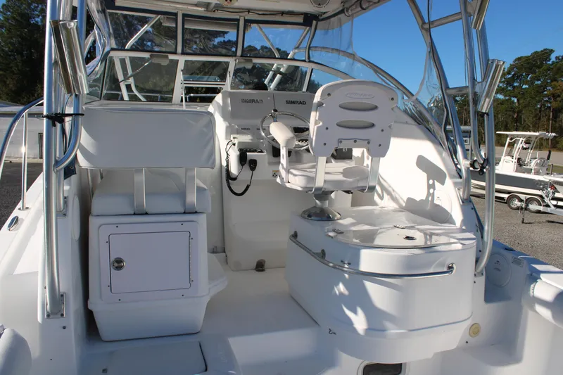 Slide: The Image of 2008 Pro-Line 29 Express O/B boat interior with helm and seating area. - 16