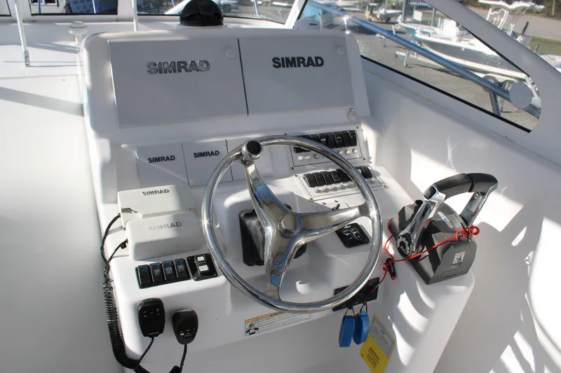 Slide: The Image of Control panel of 2008 Pro-Line 29 Express O/B boat with Simrad electronics. - 23
