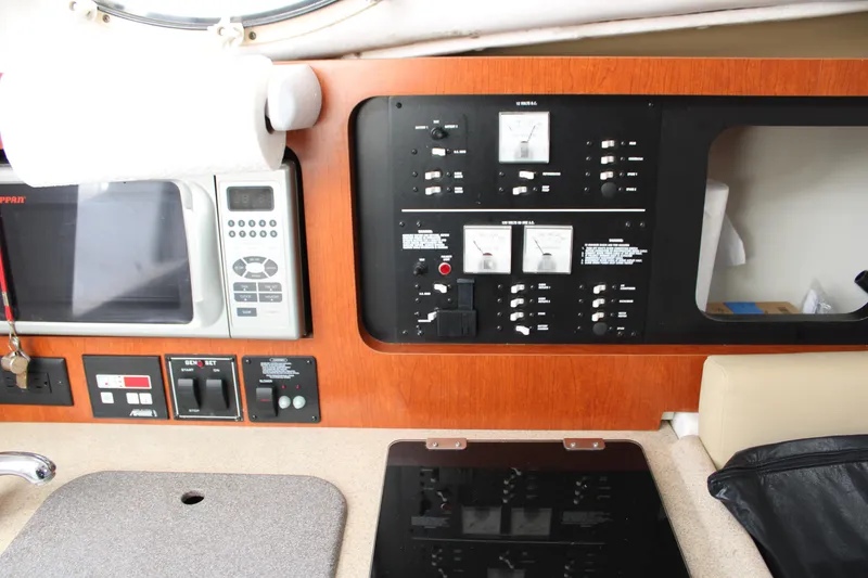 Slide: The Image of Control panel and kitchen area of 2008 Pro-Line 29 Express O/B boat interior. - 28