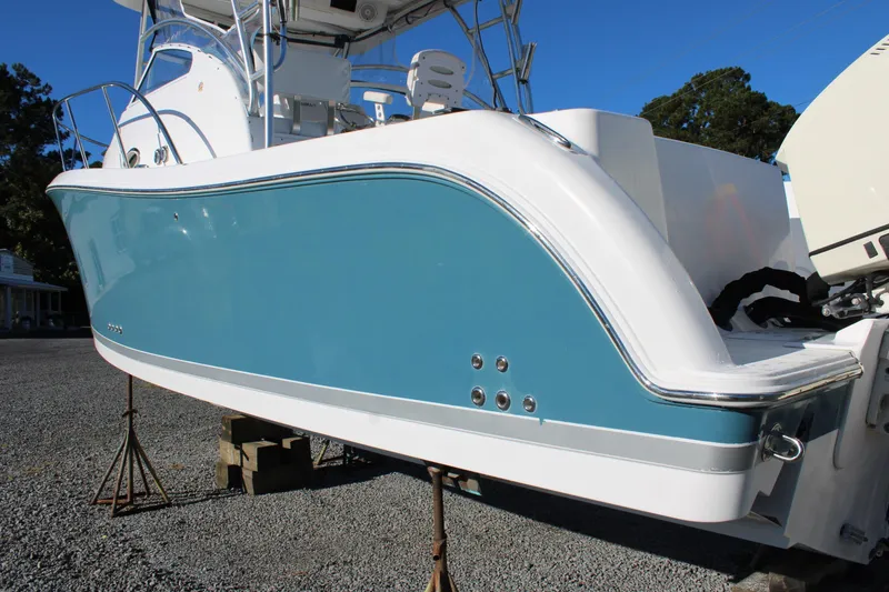 Slide: The Image of 2008 Pro-Line 29 Express O/B boat with blue and white hull on display. - 3