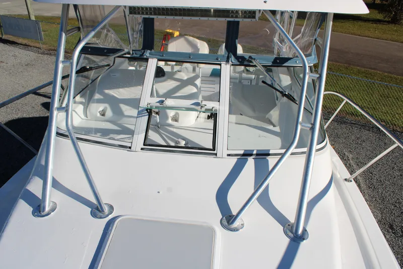 Slide: The Image of 2008 Pro-Line 29 Express O/B boat with sleek white deck and sturdy railings. - 34