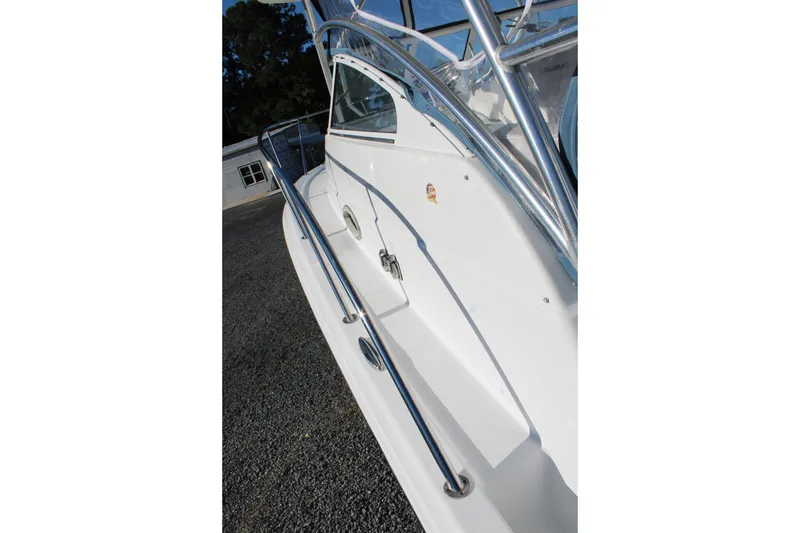Slide: The Image of 2008 Pro-Line 29 Express O/B boat with sleek white exterior and stainless steel railings. - 35
