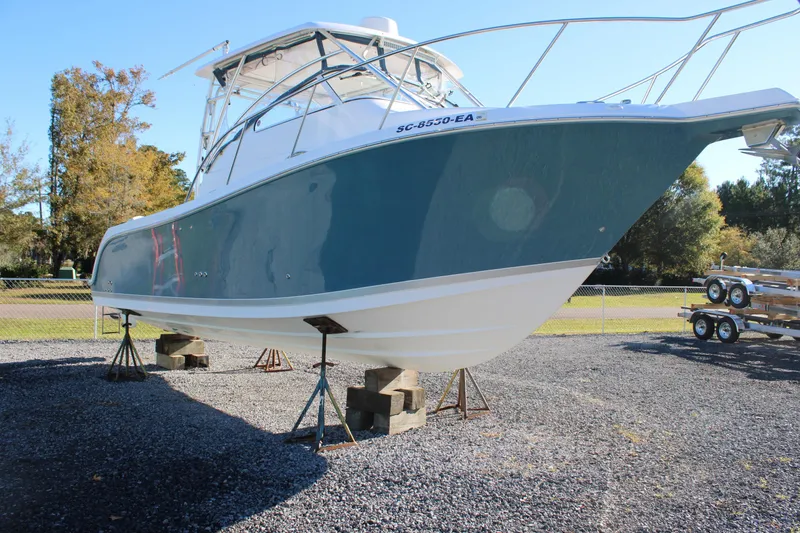Slide: The Image of 2008 Pro-Line 29 Express O/B boat on stands, outdoor display. - 6