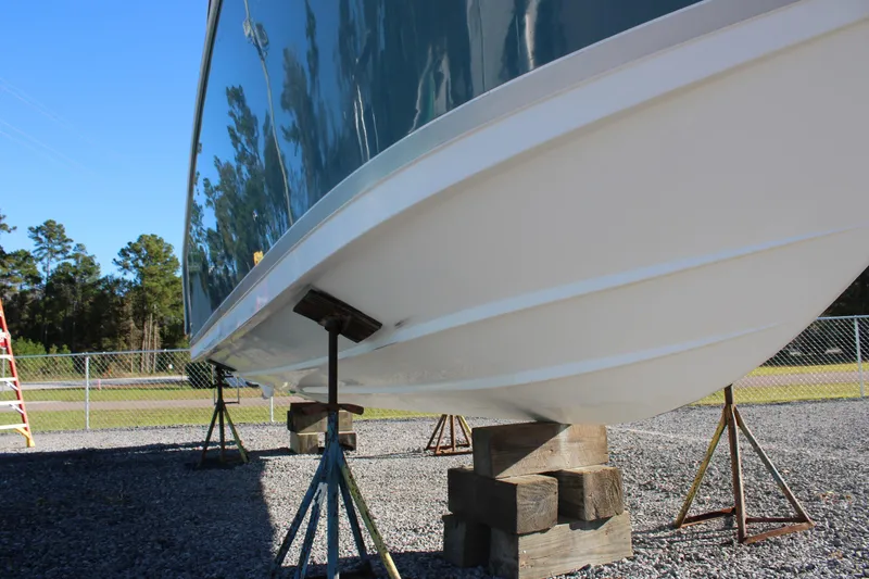 Slide: The Image of Pro-Line 29 Express O/B 2008 boat hull on stands, outdoor storage. - 8