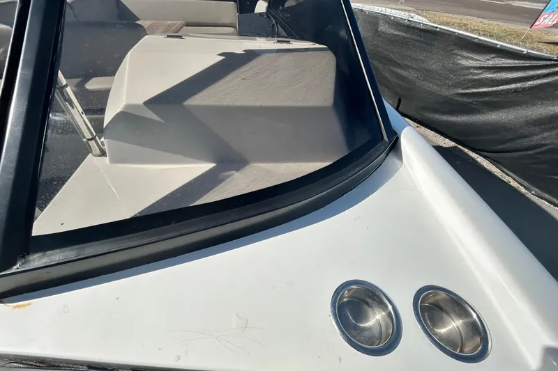 Slide: The Image of 2022 Rand Supreme 27 boat interior with windshield and cup holders. - 39