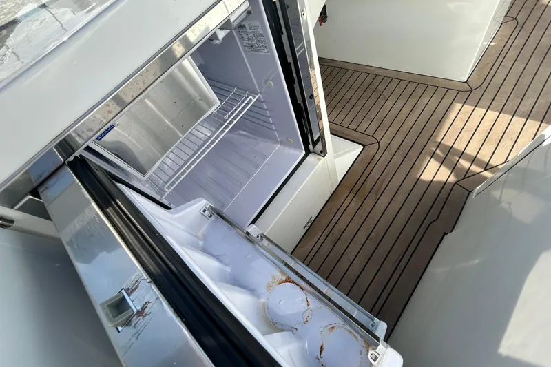 Slide: The Image of Open refrigerator on Rand Supreme 27 boat, 2022 model, with teak deck flooring. - 42