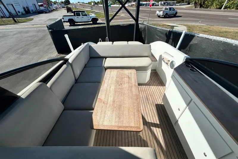 Slide: The Image of Luxurious 2022 Rand Supreme 27 boat interior with spacious seating and wooden table. - 53