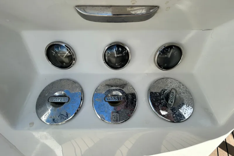 Slide: The Image of Control panel of Rand Supreme 27 boat, featuring water, waste, and fuel gauges. - 58