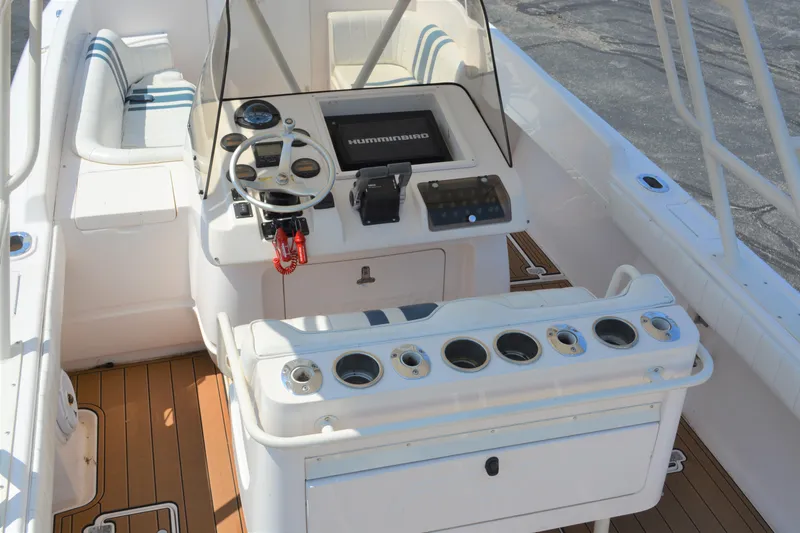 Slide: The Image of 2001 Intrepid 322 Cuddy boat cockpit with steering wheel and control panel. - 10