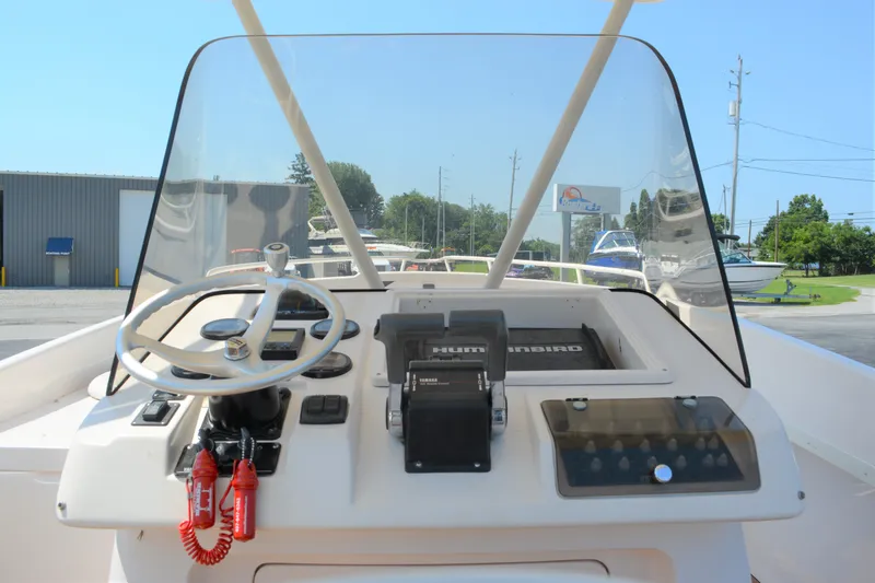 Slide: The Image of 2001 Intrepid 322 Cuddy boat helm with steering wheel and controls. - 15