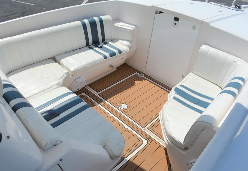 Slide: The Image of 2001 Intrepid 322 Cuddy boat interior with white and blue seating. - 18
