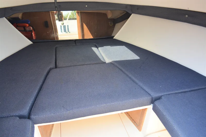 Slide: The Image of 2001 Intrepid 322 Cuddy cabin interior with blue cushions and wooden accents. - 20